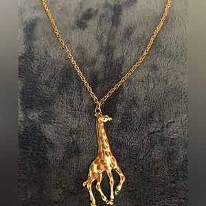 Giraffe pendant on necklace chain.